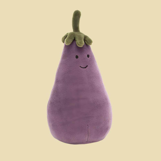 Plush toy shaped like an eggplant on a beige background