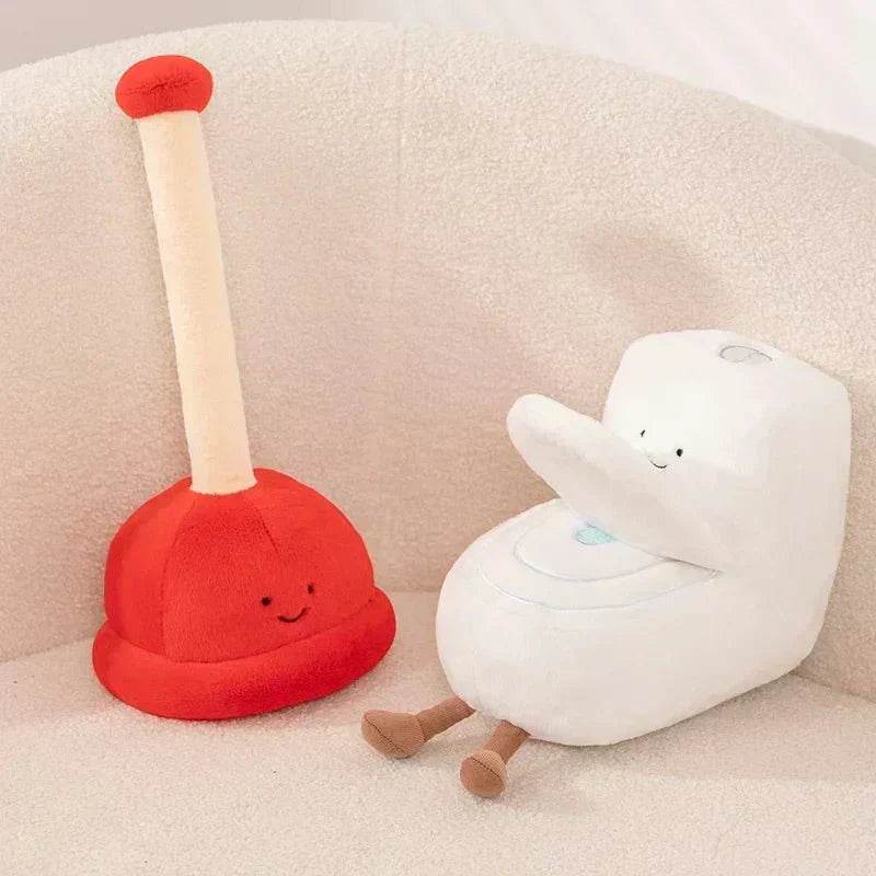 Red plush toy with a smiling face and a white plush toy with a blue heart on a beige couch.